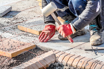 Laying of paving slabs manually