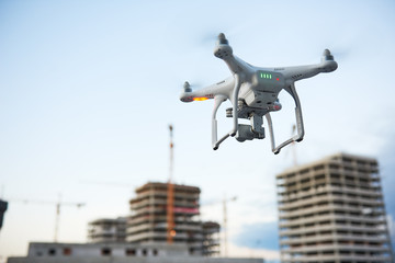 Wall Mural - drone over construction site. video surveillance or industrial inspection