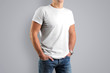 © olegphotor - Mockup white T-shirts. A young athletic man