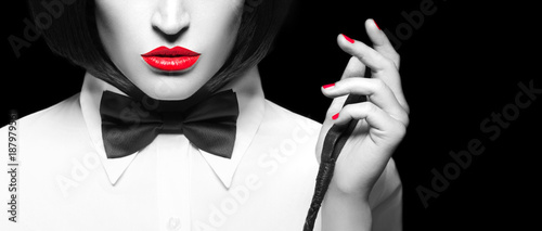 Fototapeta na szkło Sexy dominatrix in wig and with whip closeup banner, selective coloring isolated