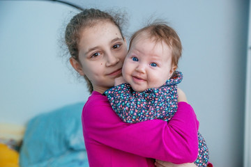 Girl child with sister baby.