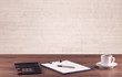 Office desk closeup with white brick wall