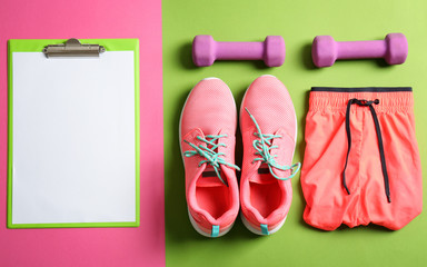 Canvas Print - Clipboard with blank paper for exercise plan and gym stuff on color background. Flat lay composition