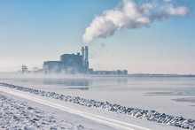 Dutch Frozen Lake Covered With Haze And View At A Power Plant