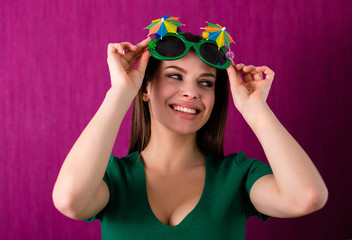 Woman wearing party glasses celebrates St. Patrick's Day