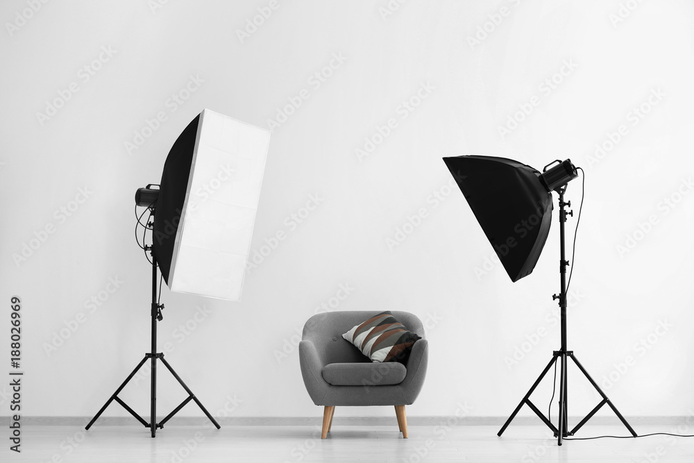 Interior of modern photo studio with armchair and professional equipment - obrazy, fototapety, plakaty 