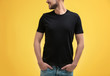 © Africa Studio - Young man in black t-shirt on color background. Mockup for design
