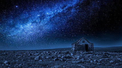 Wall Mural - small stone cottage and milky way at night, iceland