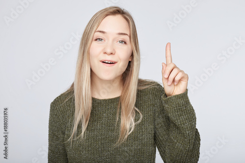 Cuadros en Lienzo Positive glad female says: wow how exciting it is, has amazed expression, indicates at blank copy space for your advertisement or promotional content