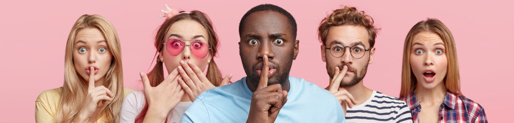 Wall Mural - Horizontal shot of five different people show hush sign, look with stupefied expression, demand complete silence, isolated over pink background. Composition of mixed race people with one interest