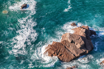 Wall Mural - beautiful natural abstract background, turquoise water and waves are broken against a stone. Cabo da Roca, Portugal. The power of the ocean