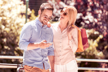 Canvas Print - Couple taking a selfie after shopping outside.