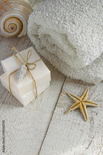 Fotografie, Obraz Spa set products-two soap bars, soft towels and sea shells on wooden background