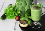 Fototapeta Kuchnia - Blended green smoothie with ingredients on wooden table
