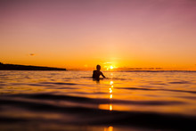 Sunset In Bali And Surfer Waiting For Wave