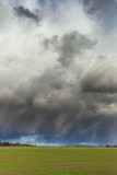 Fototapeta Tęcza - Dark clouds over land.