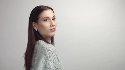 Wall Mural - spanish woman turning on camera and looking at it in studio