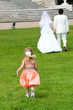 A beautiful girl is running after the newlyweds