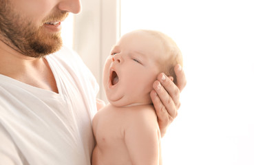 Poster - Father with cute yawning baby at home