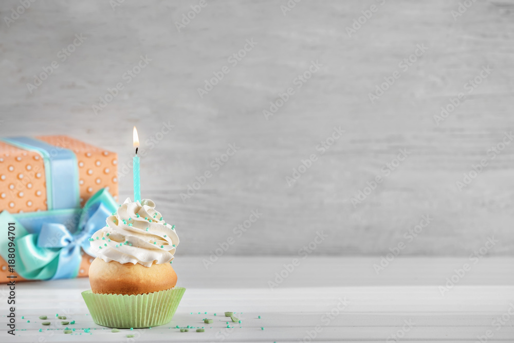 Birthday cupcake with candle on table