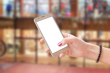 Poster - Mobile phone in woman hand with isolated screen for mockup. Business center in background.