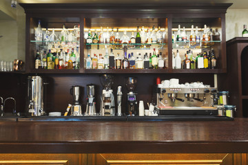 Bar counter with alcohol bottles assortment