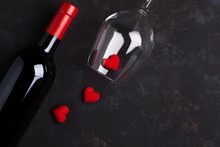 Bottle And Glass Of Wine With Red Hearts On The Old Black Rusty Floor.