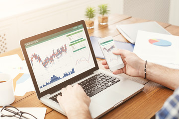 Fototapete - Laptop with financial statistics on a desktop