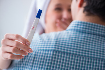 Wife and husband looking at pregnancy test