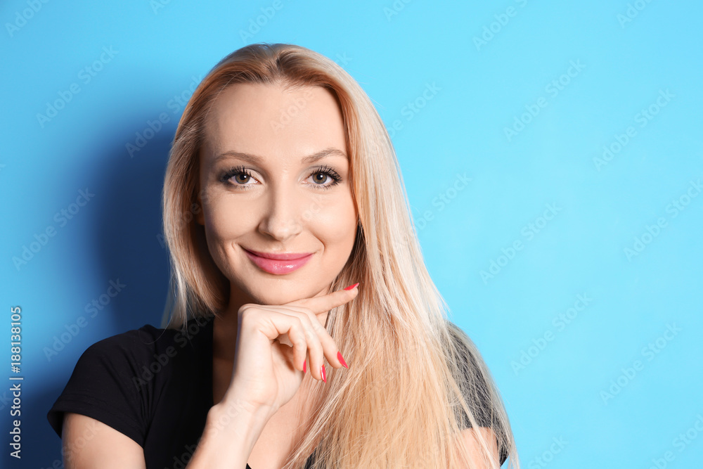 Beautiful smiling woman on color background