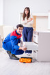 © Elnur - Contractor repairman assembling furniture under woman supervisio