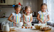 © JenkoAtaman - happy sisters children girls bake cookies, knead dough, play with flour and laugh  .
