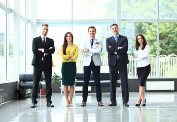 Wall Mural - Happy business team with arms crossed at the office.