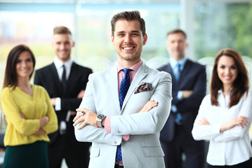 Wall Mural - Happy business team with arms crossed at the office.