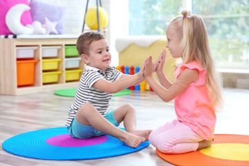 Canvas Print - Cute little children playing on floor at home