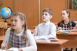© Oksana Kuzmina - School kids at desk in elementary school lesson