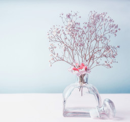 Wall Mural - wellness or aromatherapy concept. glass jar diffuser with flowers at pastel color background, top vi