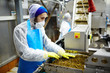 © pressmaster - Young man in uniform working at seaweed salad producing-line