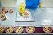 © pressmaster - Seafood processing plant staff checking weight of mussels in small plastic container before packing
