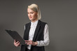 © LIGHTFIELD STUDIOS - portrait of stylish businesswoman with notepad isolated on grey