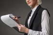 © LIGHTFIELD STUDIOS - partial view of businesswoman with notepad isolated on grey