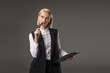 © LIGHTFIELD STUDIOS - portrait of stylish businesswoman with notepad isolated on grey