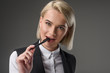 © LIGHTFIELD STUDIOS - portrait of beautiful young businesswoman with pen isolated on grey