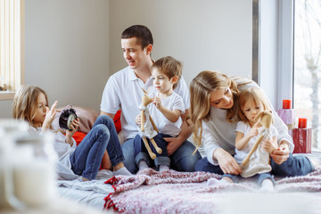 Wall Mural - Happy family having fun together at home in bedroom