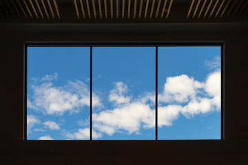 Look up the clear blue sky through the glass in the sunny day