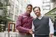 © Monkey Business - Two middle aged men shaking hands outside their workplace