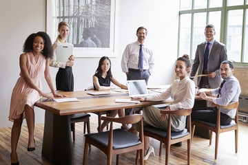 Wall Mural - Young professionals at business meeting turn to face camera