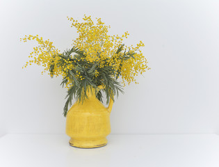 Wall Mural - bouquet of mimosa in vintage cracked yellow vase