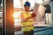 © NDABCREATIVITY - Picture of construction site engineer looking at plan