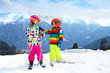 © famveldman - Ski and snow winter fun for kids. Children skiing.